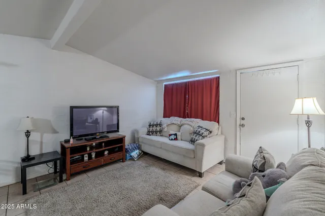 a kitchen with cabinets and chairs