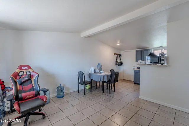 a view of a room with gym equipment and large windows