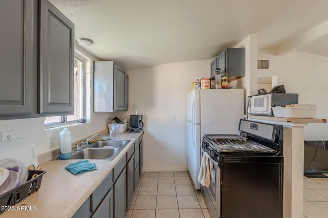 a kitchen with a sink cabinets and window