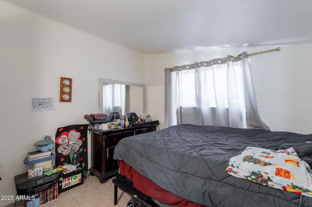 a bedroom with a bed and hallway