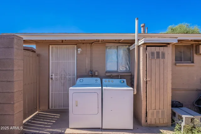 a backyard of a house with table and chairs