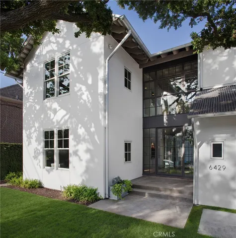 a living room with furniture and a bookshelf