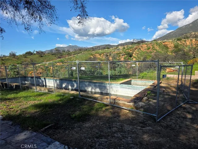 a view of a swimming pool with a yard