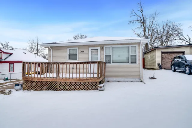 a view of a house with a wooden deck