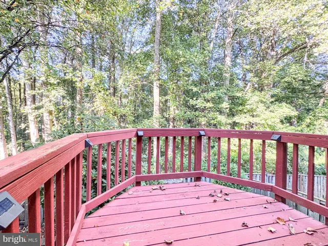 a view of balcony with wooden floor and fence