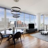 a living room with furniture and a floor to ceiling window