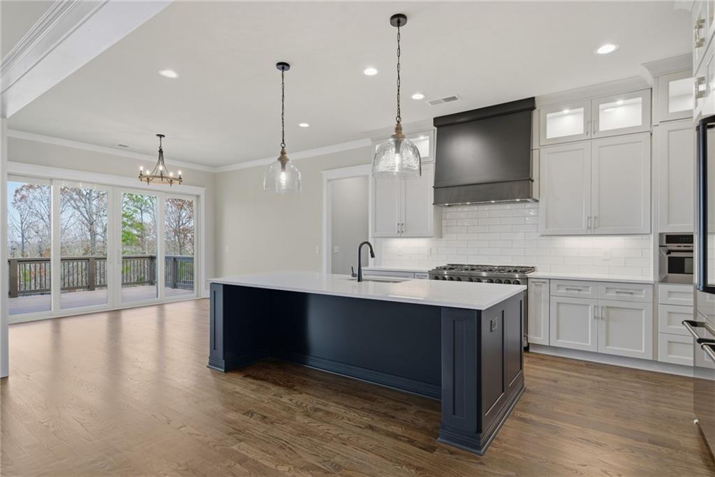 5364 Price Road Gainesville, GA 30506 - Photo 20 of 59 a kitchen with stainless steel appliances granite countertop a stove and a wooden floors