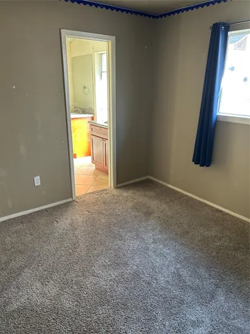 a view of a room with a tub and a mirror