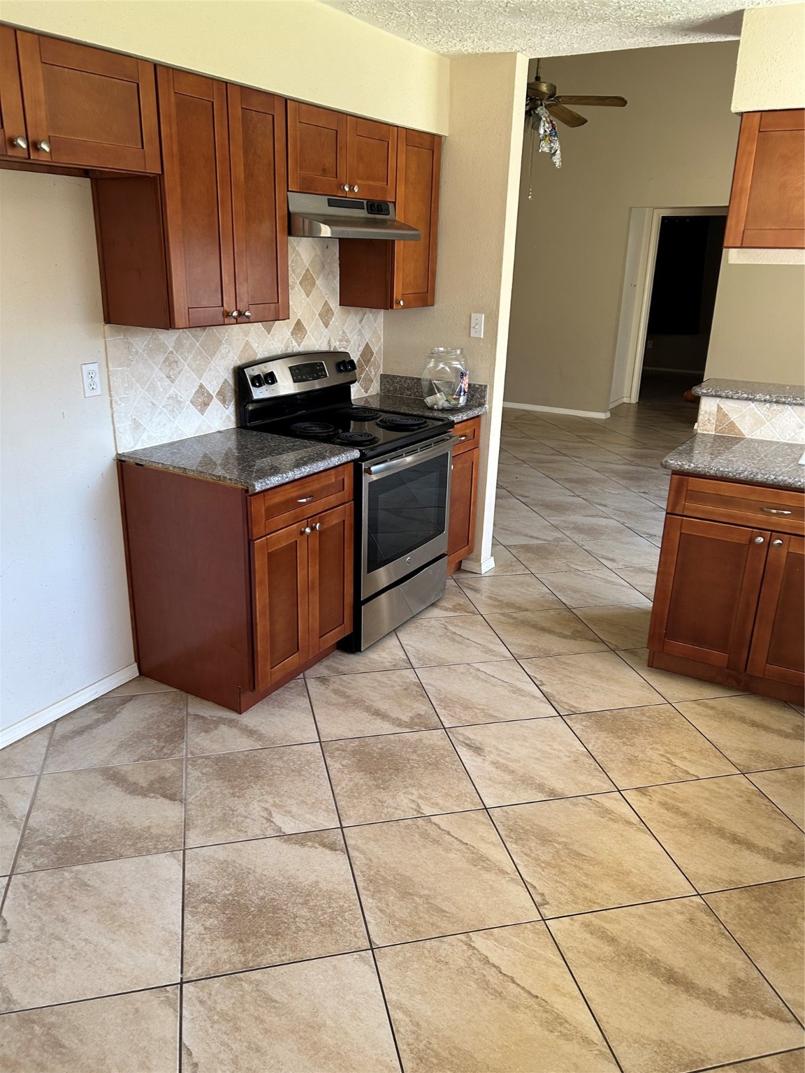 23119 Tree Bright Lane Spring, TX 77373 - Photo 3 of 17 a kitchen with stainless steel appliances granite countertop a stove a sink and a refrigerator