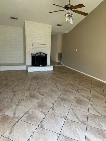 a view of empty room with fireplace