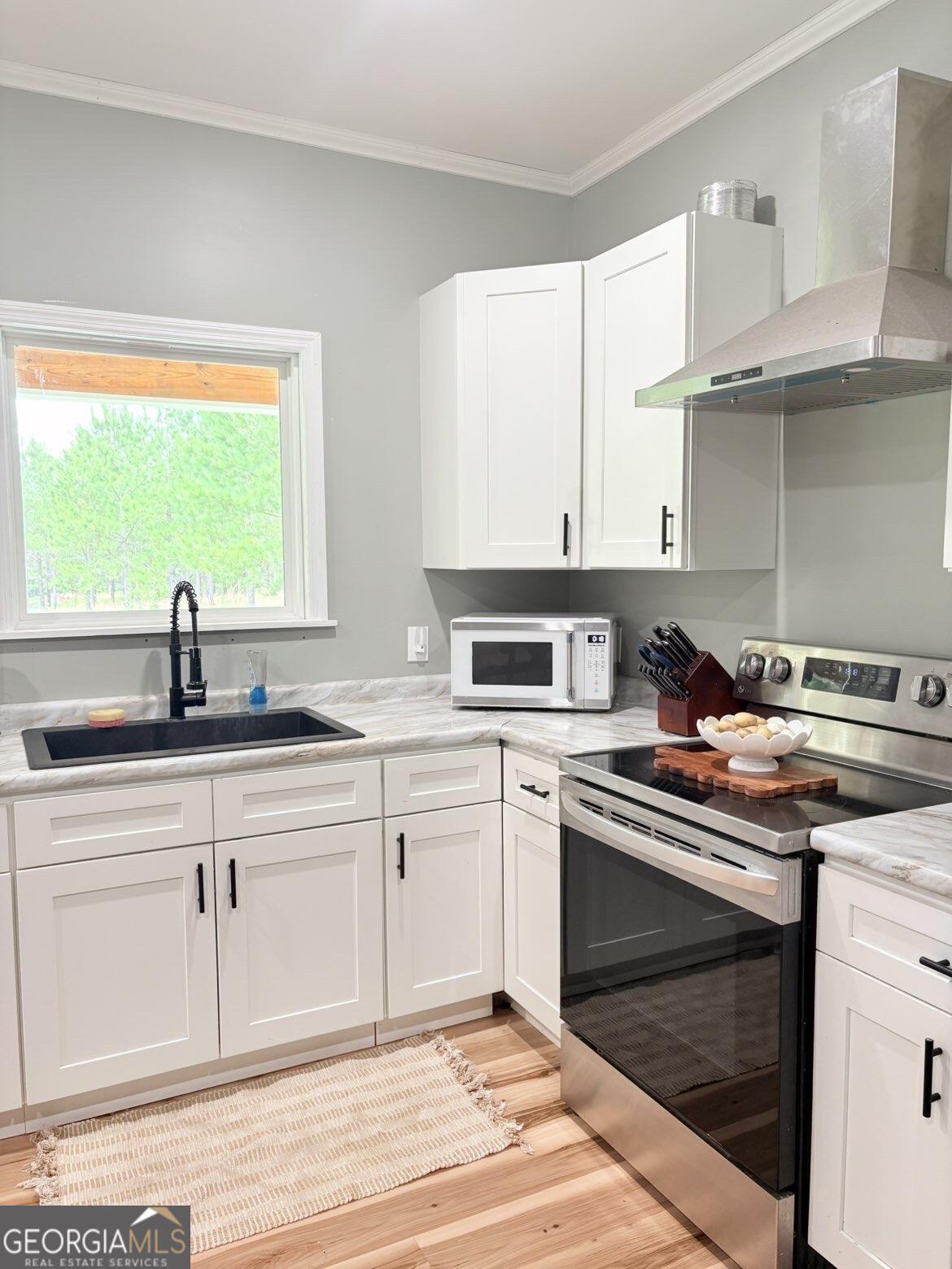 210 St Galilee Road Swainsboro, GA 30401 - Photo 5 of 18 a kitchen with stainless steel appliances granite countertop a sink stove and cabinets