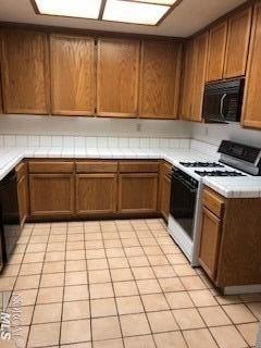 a kitchen with a sink a stove top oven and cabinets