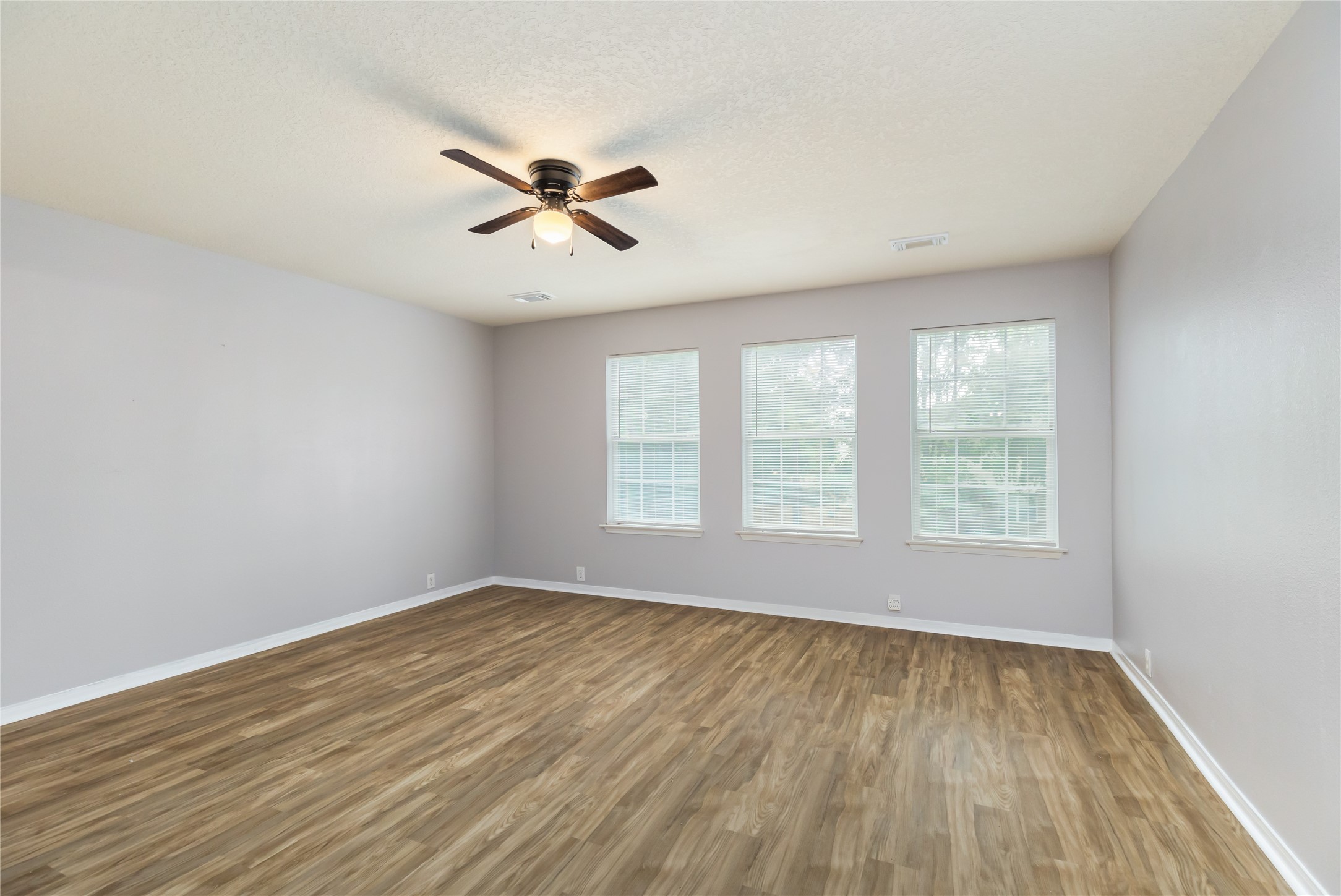 17334 Turquoise Stream Drive Houston, TX 77095 - Photo 14 of 31 a view of empty room with wooden floor and fan