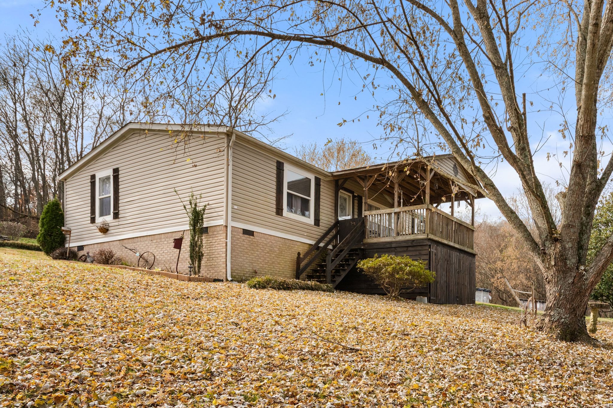 1892 Preacher Holt Road Mount Pleasant, TN 38474 - Photo 2 of 36 a front view of a house with a yard