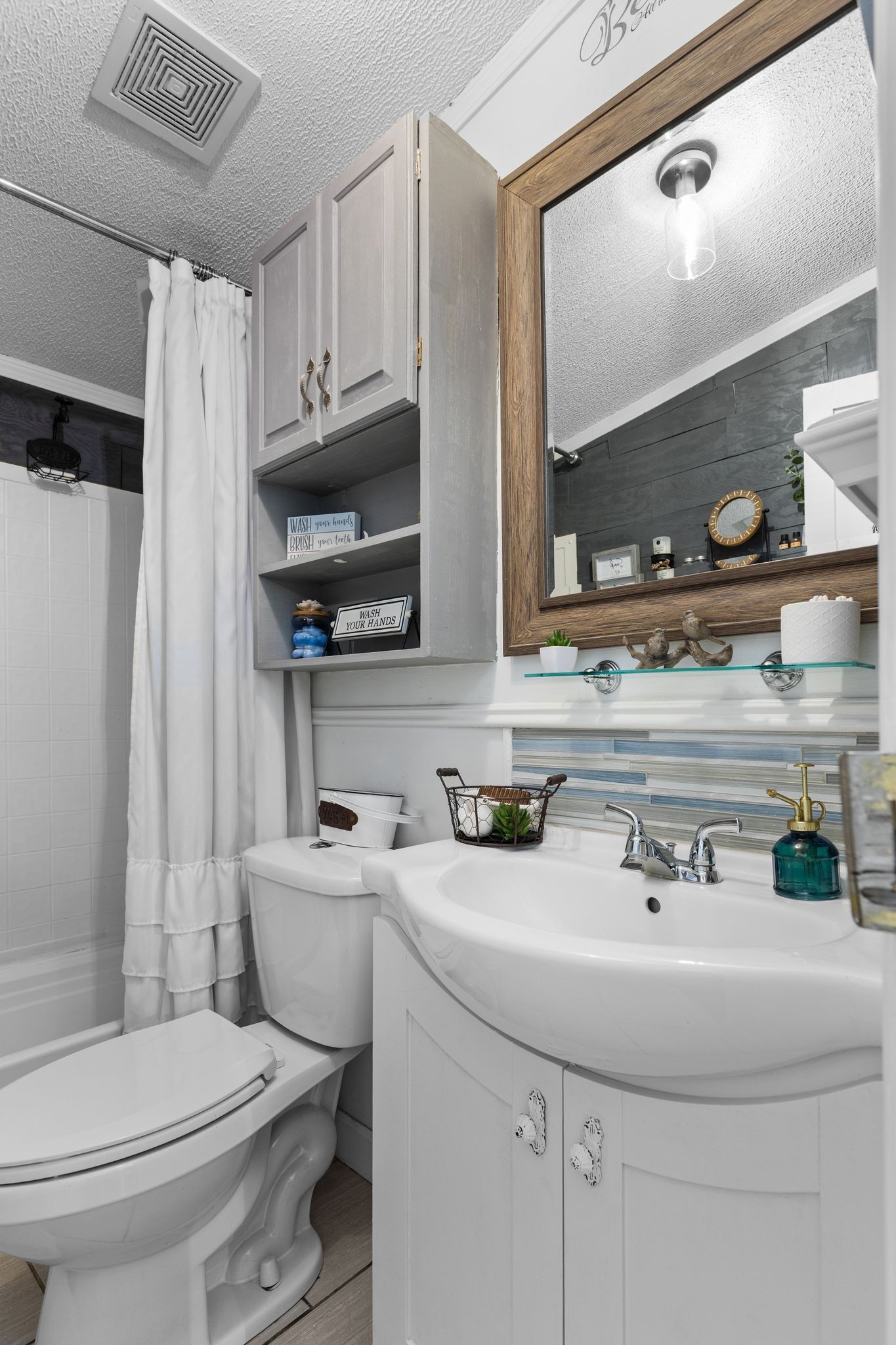 1892 Preacher Holt Road Mount Pleasant, TN 38474 - Photo 23 of 36 a bathroom with a sink a toilet and a mirror