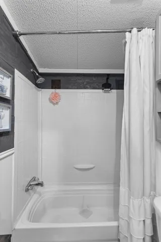 a bathroom with a shower and a tub