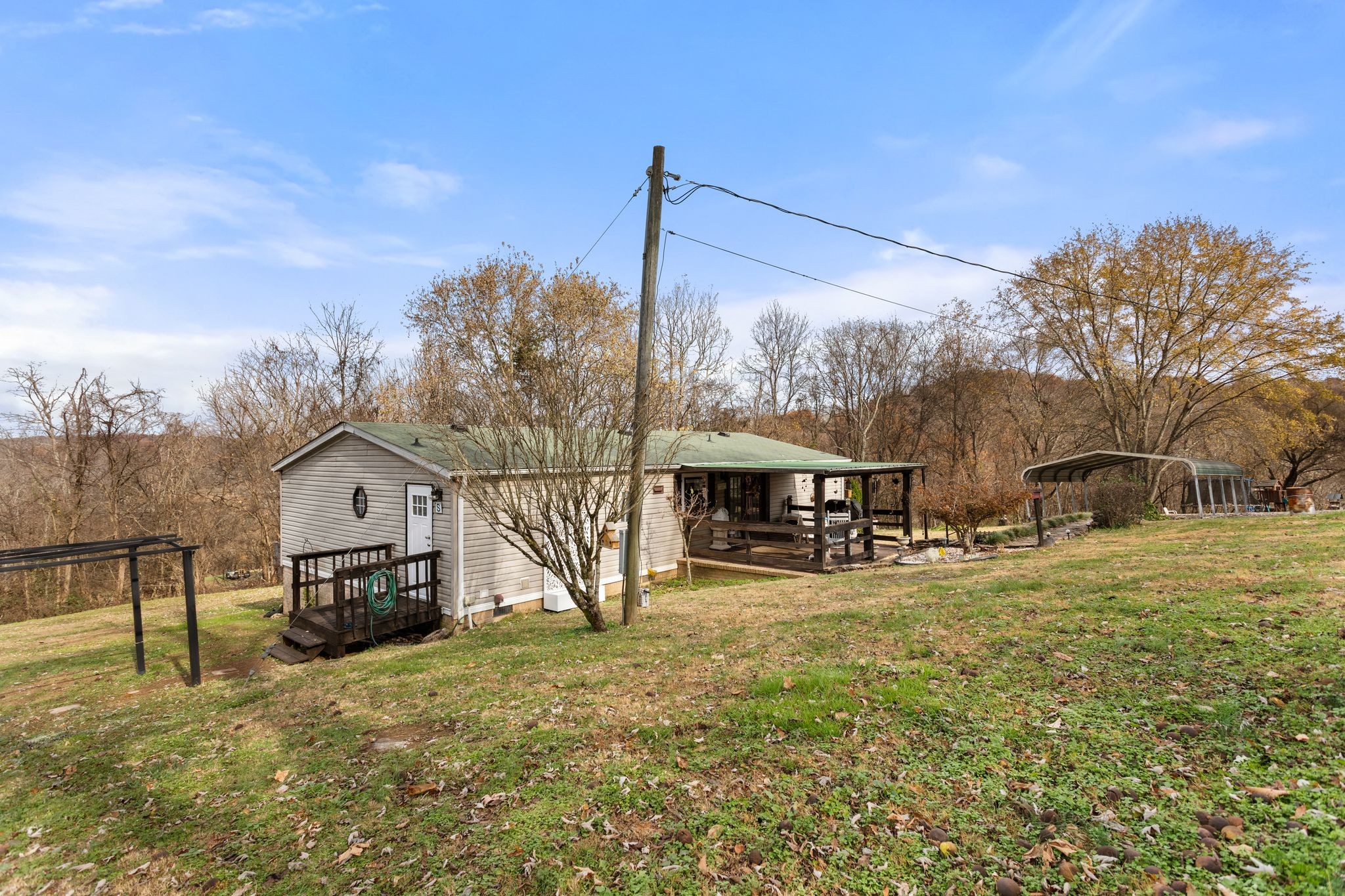 1892 Preacher Holt Road Mount Pleasant, TN 38474 - Photo 31 of 36 a view of a house with a big yard and large trees