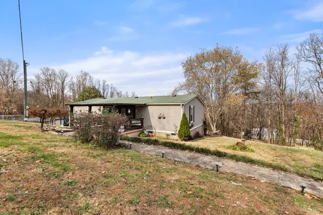 a view of a house with a yard covered in snow