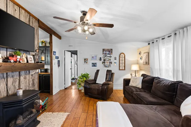 a living room with furniture and wooden floor