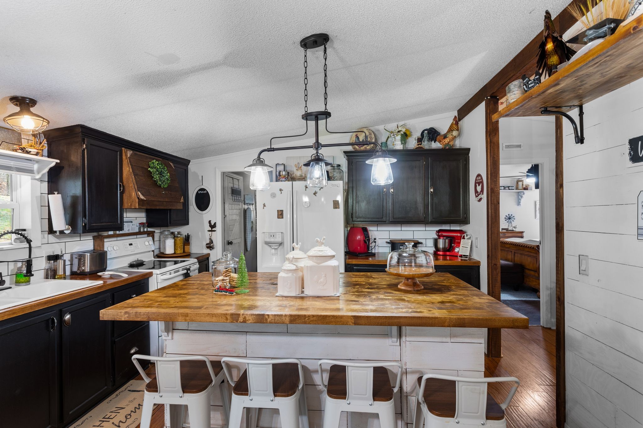 1892 Preacher Holt Road Mount Pleasant, TN 38474 - Photo 10 of 36 a kitchen area with granite countertop a sink and a refrigerator