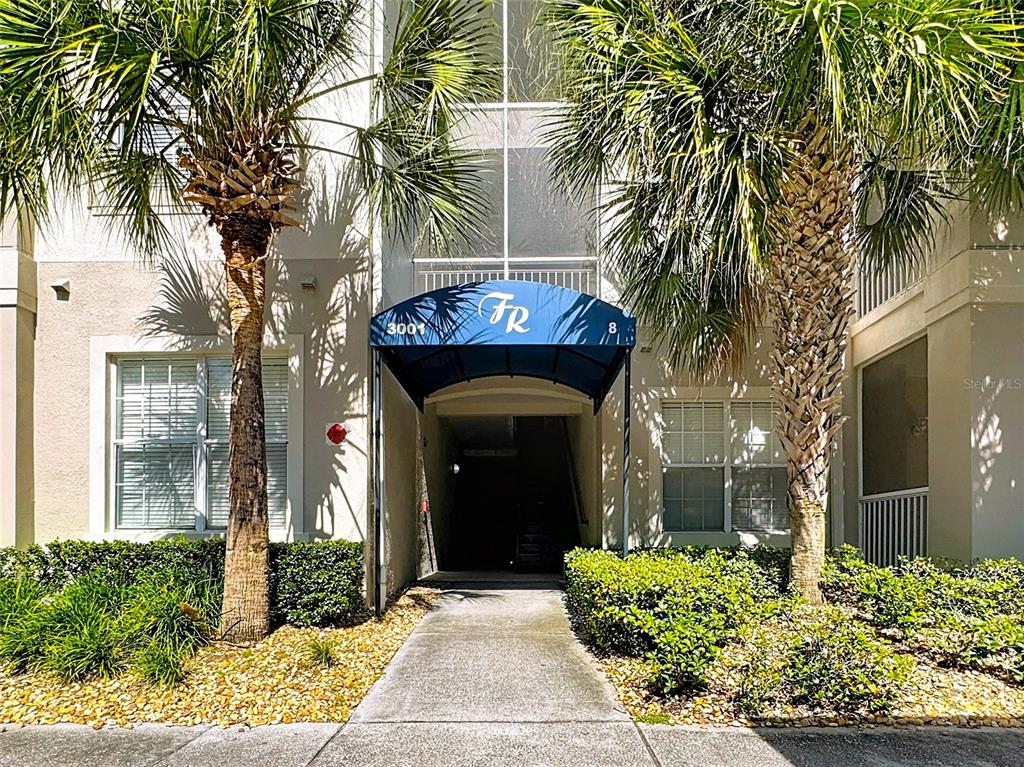 3001 Greystone Loop, Unit 208 Kissimmee, FL 34741 - Photo 1 of 1 a front view of a house with a yard