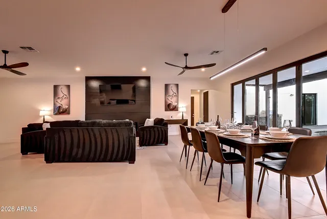 a living room with furniture and a painting on the wall