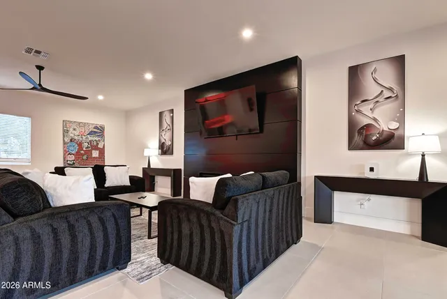 a spacious bedroom with a bed a couch and dresser