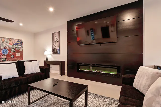 a spacious bedroom with a bed a mirror and a window