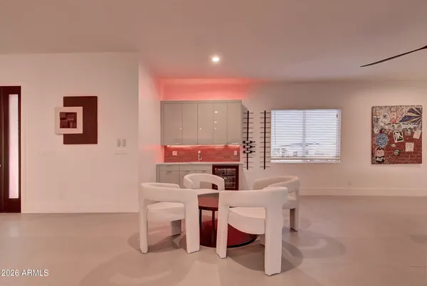 a spacious bedroom with a bed and a flat screen tv