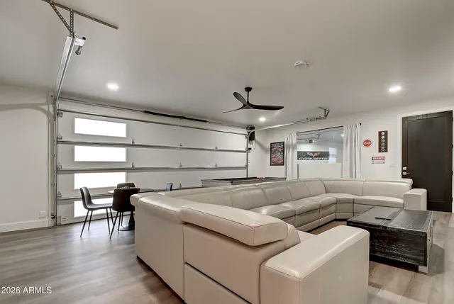 a spacious bedroom with a bed and a flat screen tv