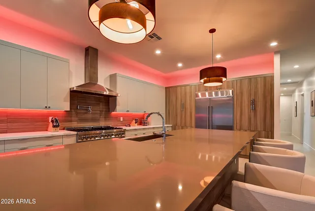 a kitchen with stainless steel appliances granite countertop a stove a sink dishwasher and a microwave with wooden floor