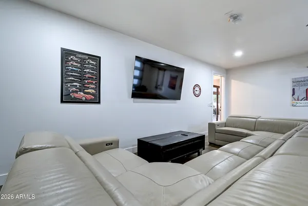 a bedroom with two beds and painting on the wall