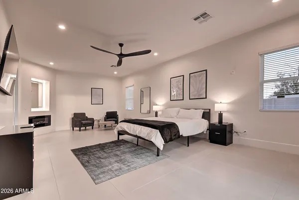 a bedroom with two beds and a flat screen tv