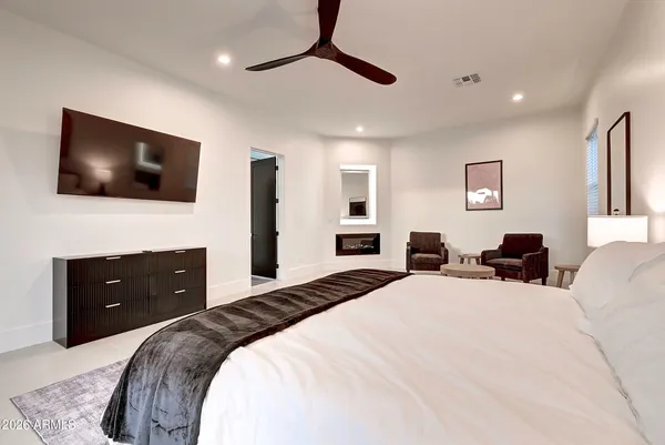 a bedroom with a bed and a flat screen tv