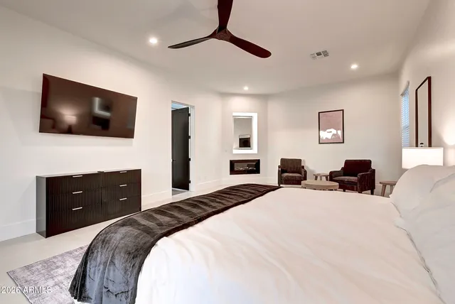 a bedroom with a bed and a flat screen tv