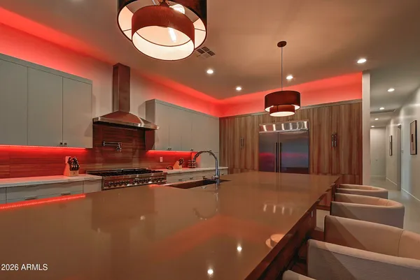 a kitchen with stainless steel appliances granite countertop a stove and a refrigerator