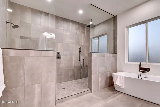a living room with furniture a rug and a floor to ceiling window