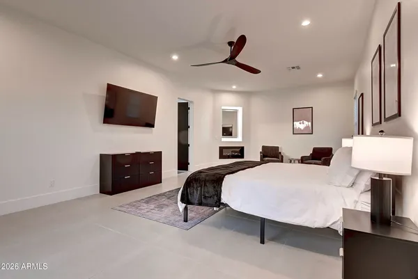 a view of a hallway with wooden floor and cabinet