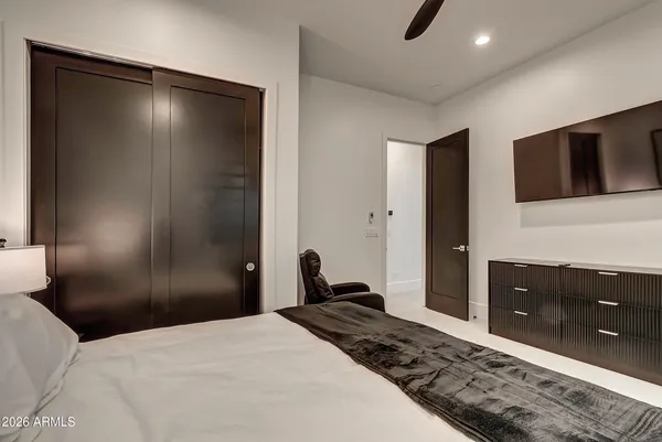 a bedroom with a bed and painting on the wall