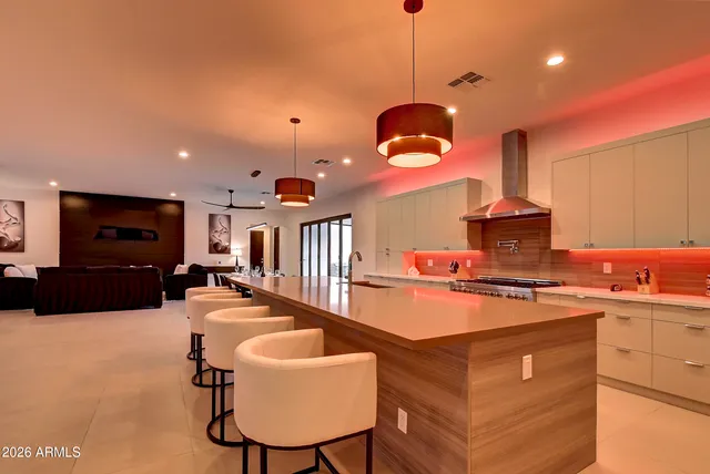 a kitchen with stainless steel appliances granite countertop a sink a stove and a refrigerator