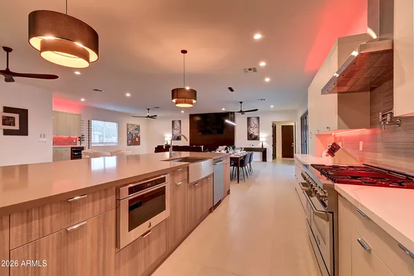 a living room with furniture a flat screen tv and a large window