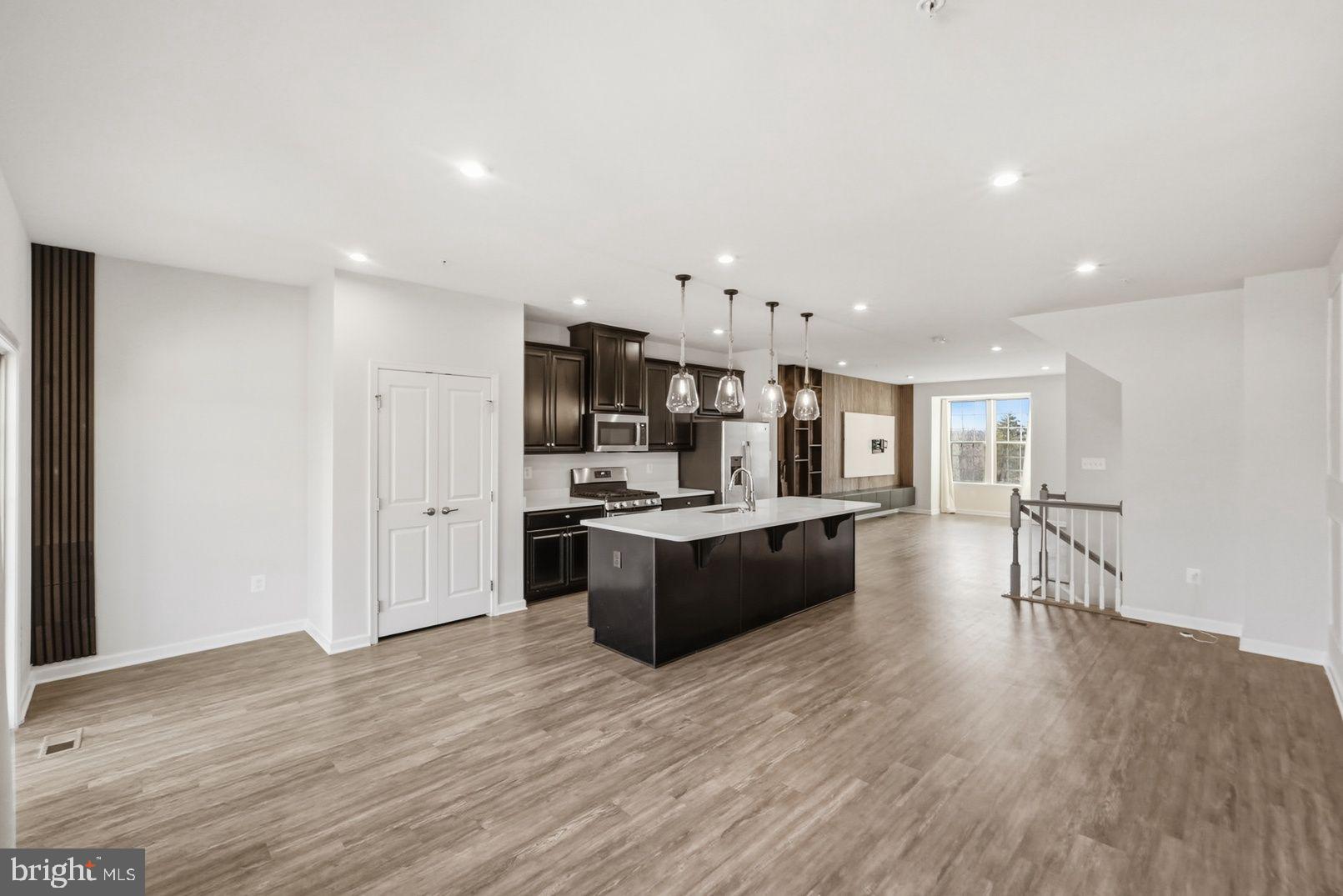 7917 Gladden Farm Way Hanover, MD 21076 - Photo 11 of 28 a large kitchen with a center island and wooden floor