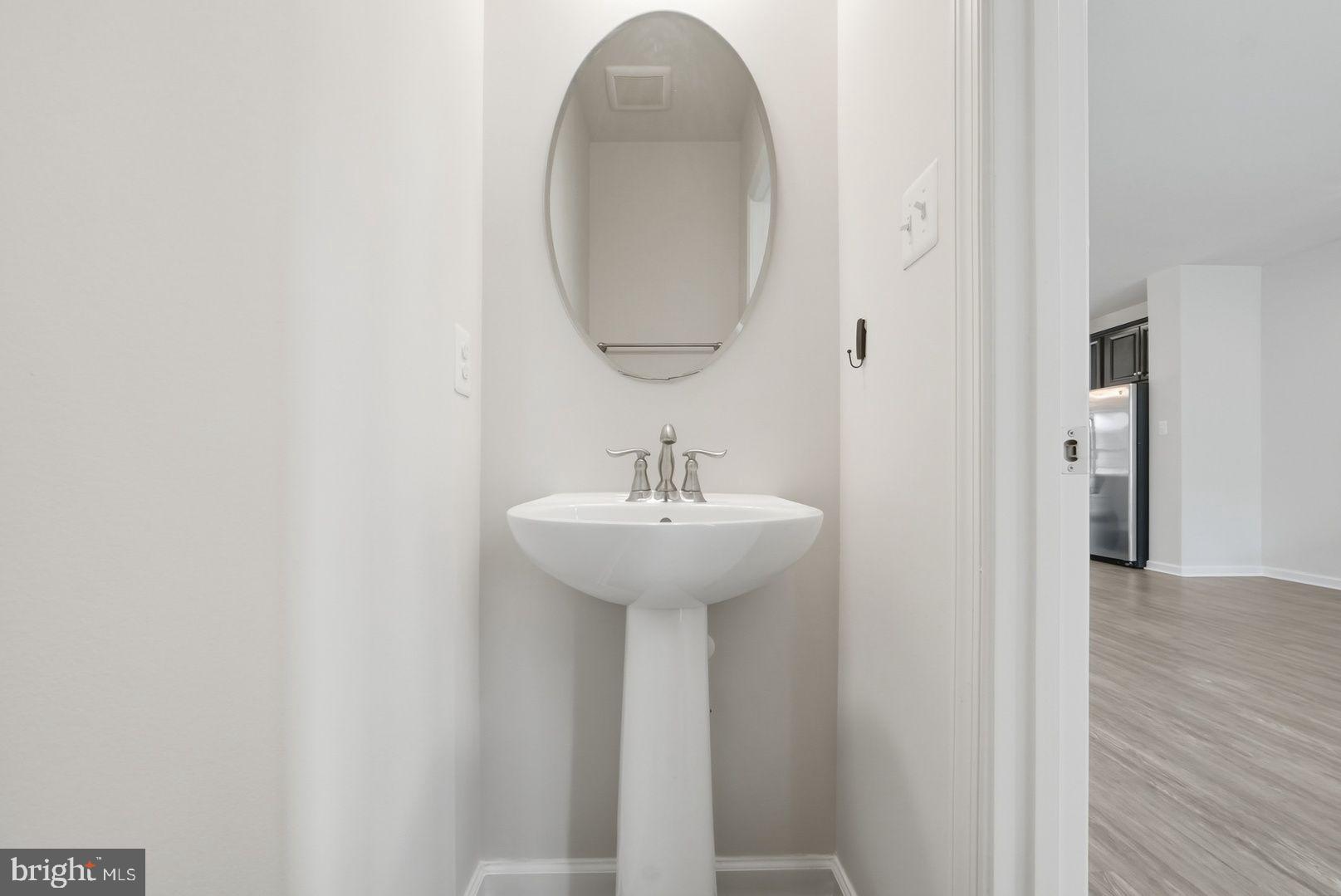 7917 Gladden Farm Way Hanover, MD 21076 - Photo 17 of 28 a bathroom with a sink and a mirror