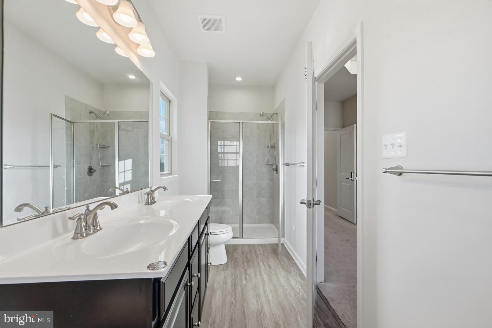 7917 Gladden Farm Way Hanover, MD 21076 - Photo 21 of 28 a bathroom with a sink a shower a mirror and a bathtub