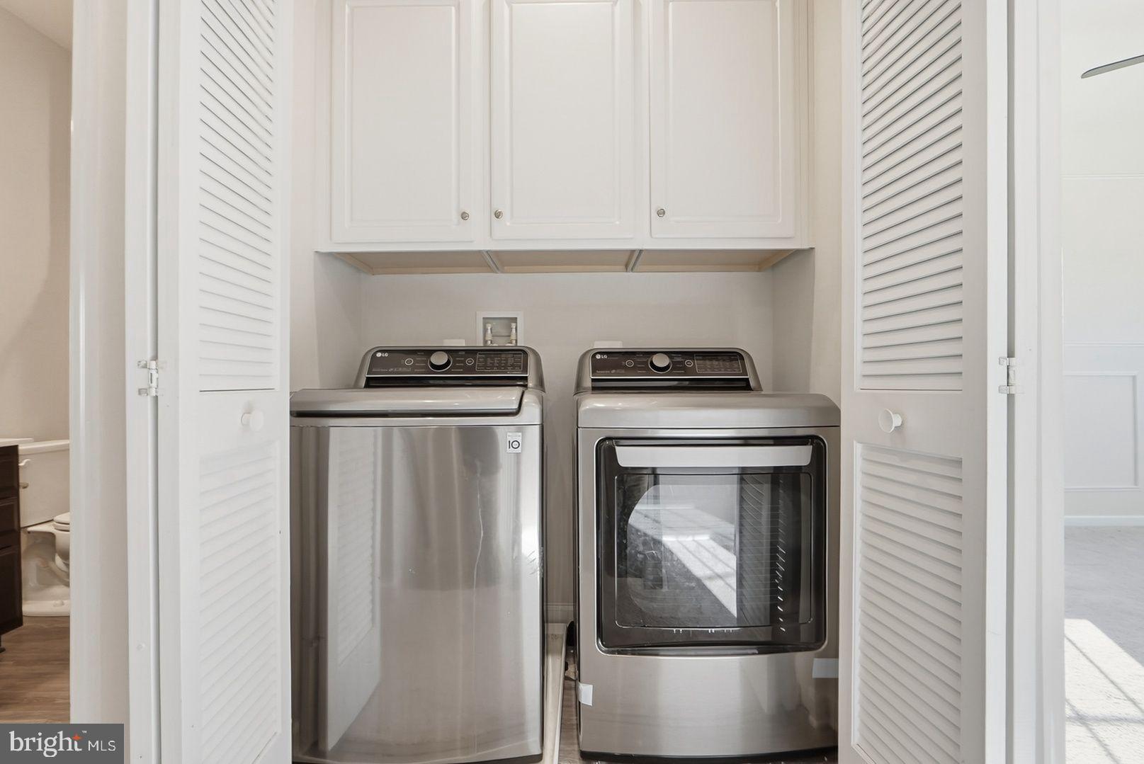 7917 Gladden Farm Way Hanover, MD 21076 - Photo 22 of 28 a kitchen with white cabinets and a stove
