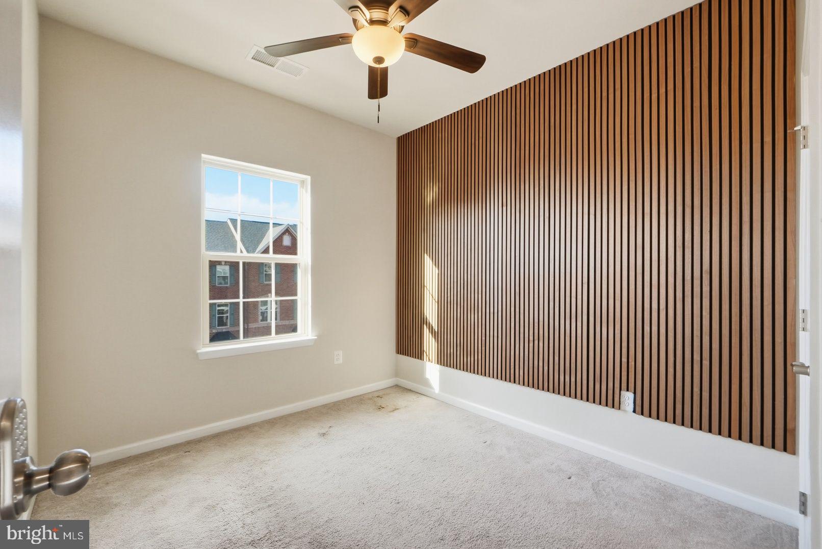 7917 Gladden Farm Way Hanover, MD 21076 - Photo 26 of 28 an empty room with windows and fan