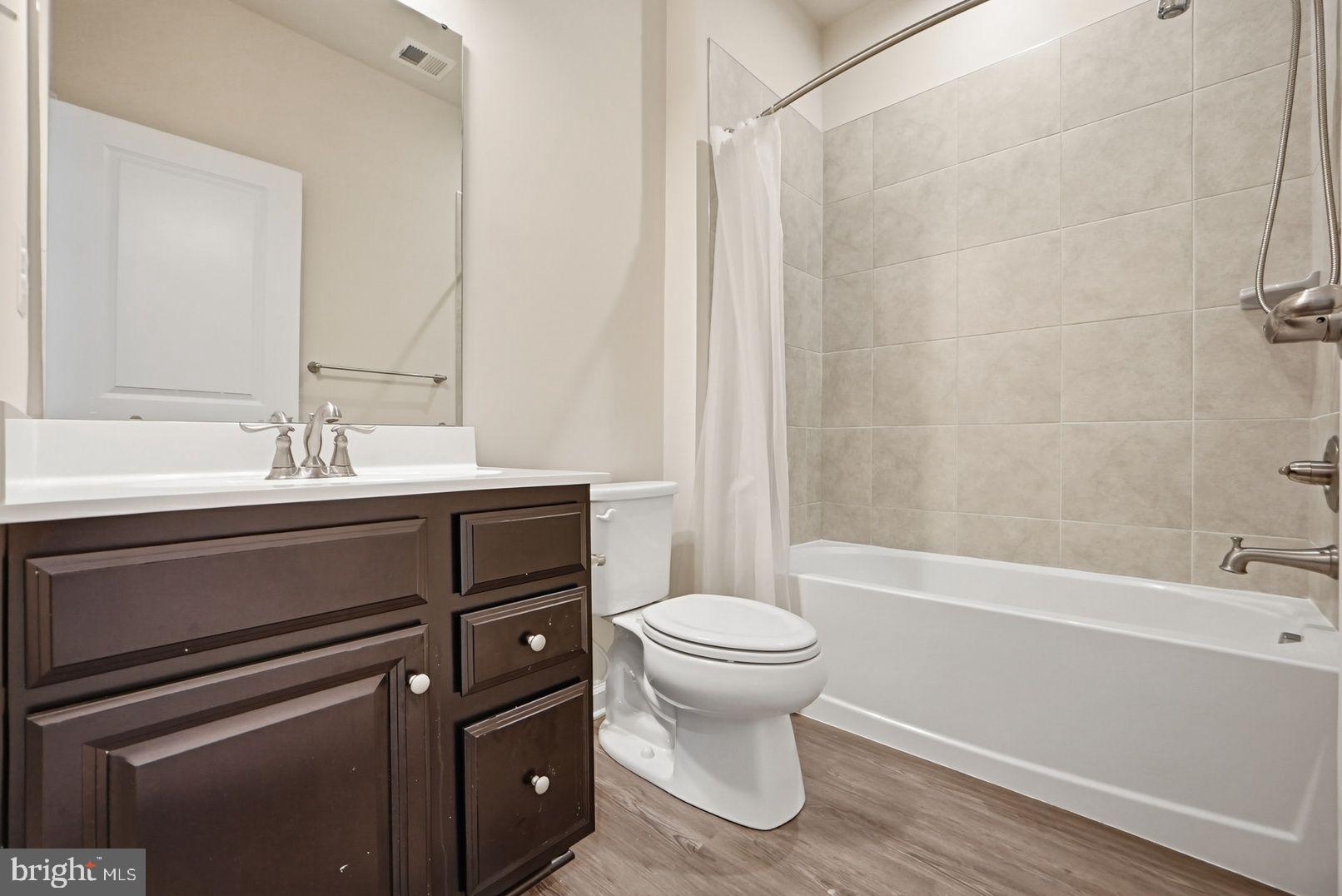 7917 Gladden Farm Way Hanover, MD 21076 - Photo 7 of 28 a bathroom with a sink toilet and shower