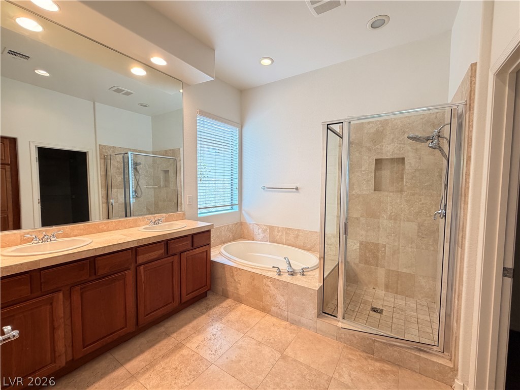 16 Caprington Road Henderson, NV 89052 - Photo 8 of 16 An integrated soaking tub and separate tiled shower highlight this spacious bathroom.