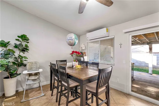 a kitchen with stainless steel appliances kitchen island granite countertop a table chairs and a refrigerator