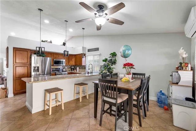 a kitchen with granite countertop a counter space stainless steel appliances and cabinets